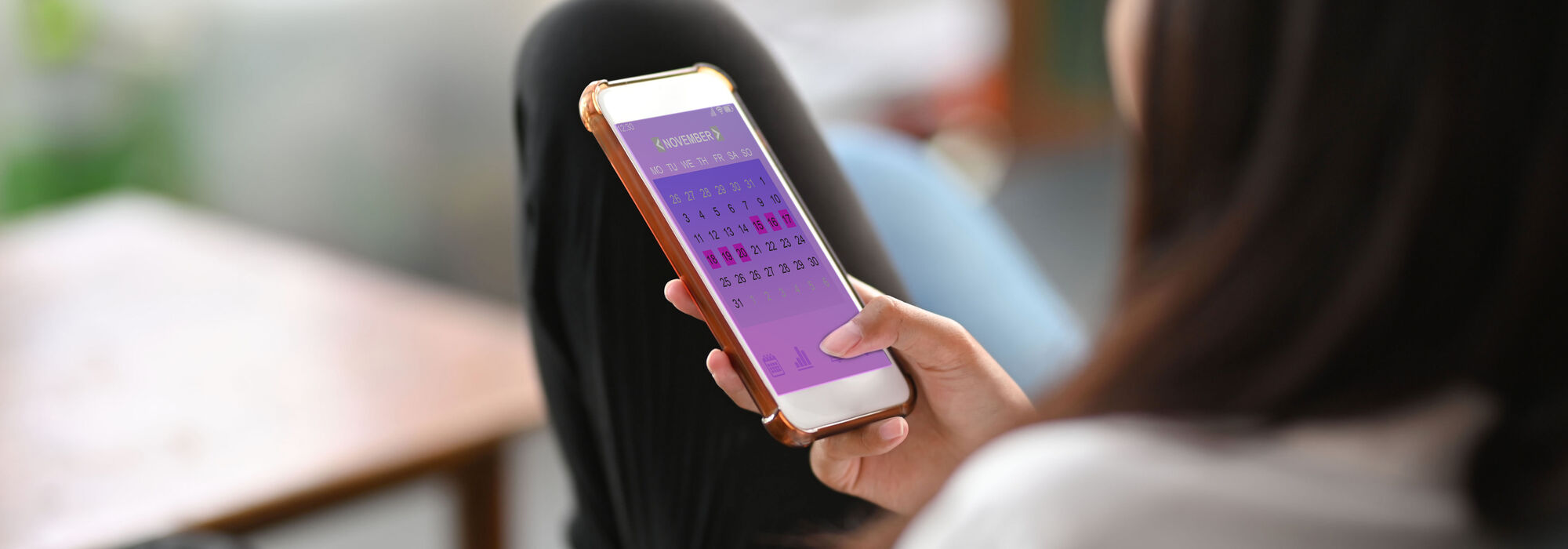 Woman using fertility tracking app on her phone