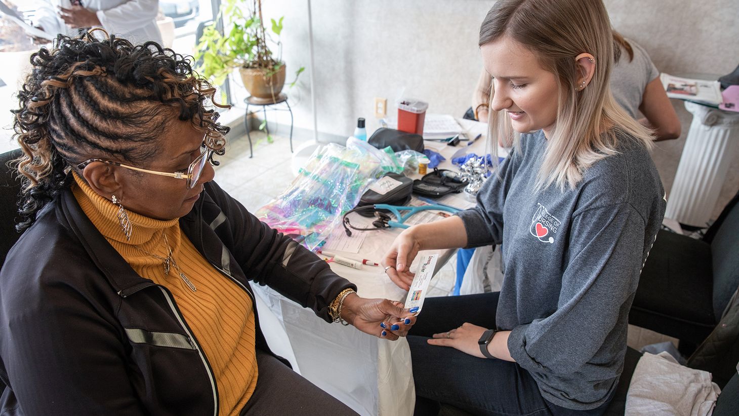 Nurse giving coupon to individual