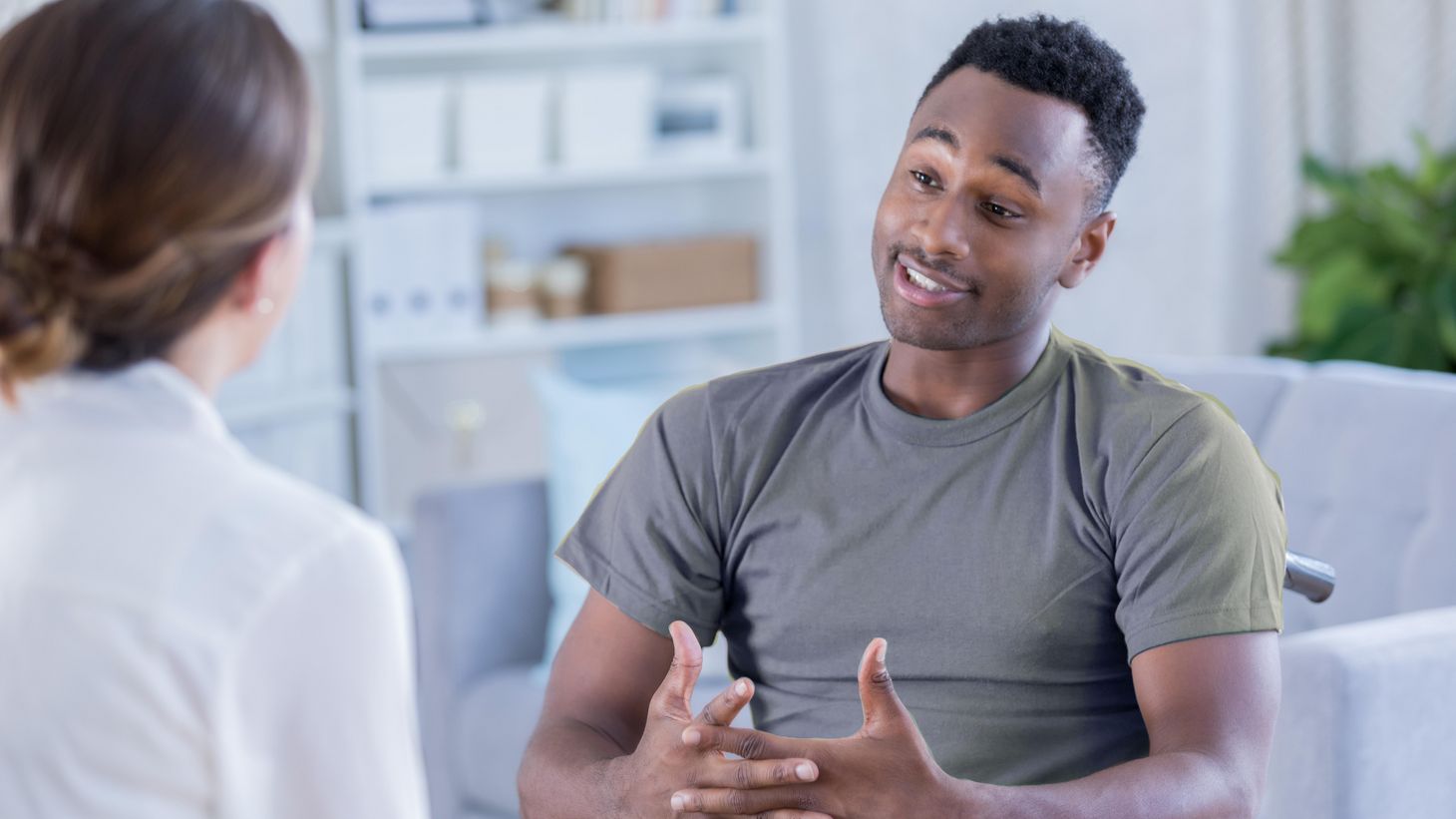 Individual sitting down and talking to a nurse
