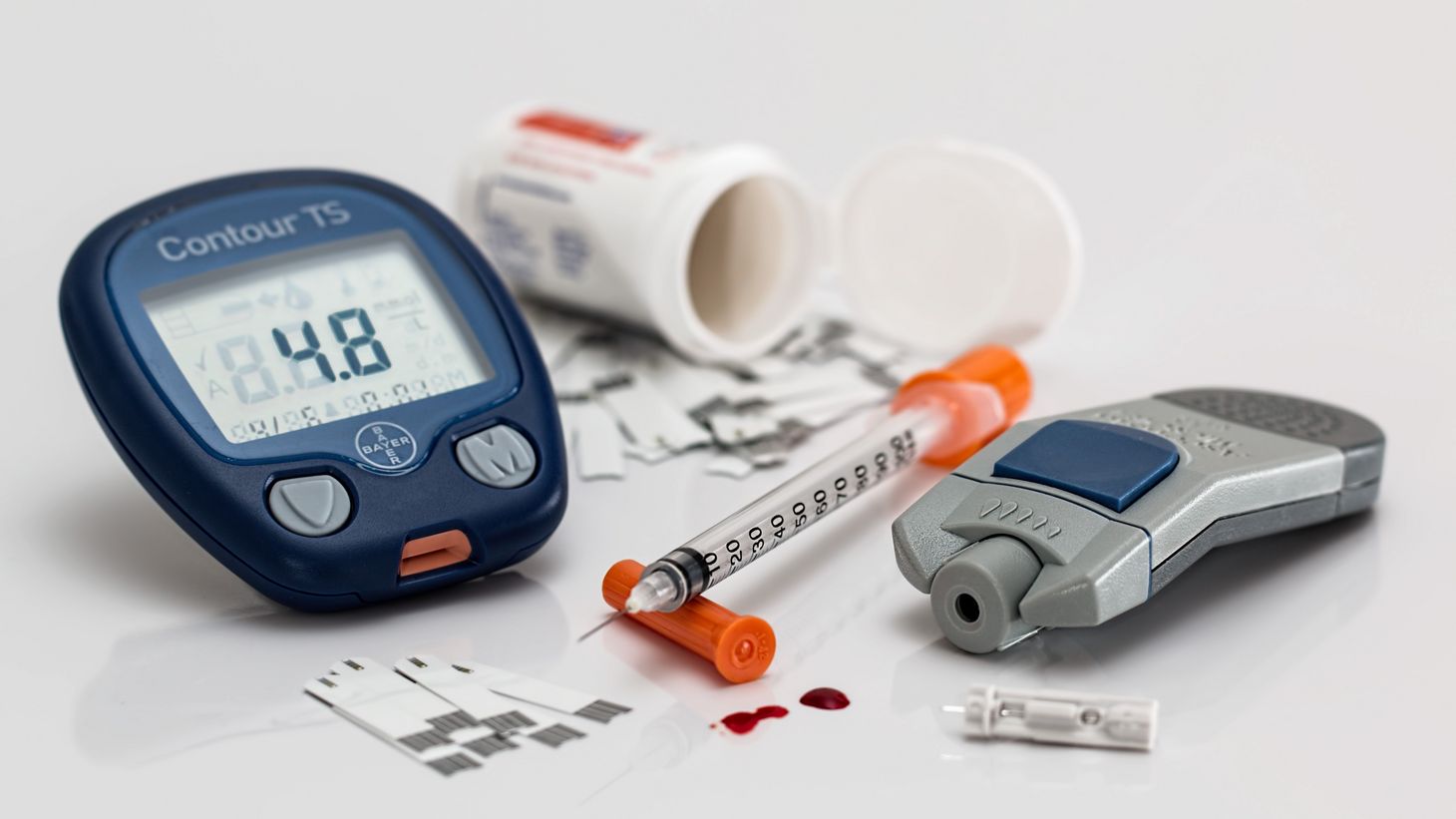 mixture of blood pressure monitor, syringe, pill bottle, etc.