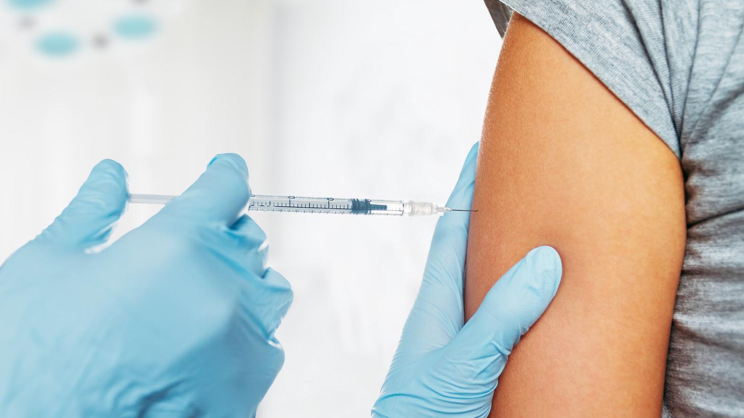 Close-up of someone getting a shot in their arm
