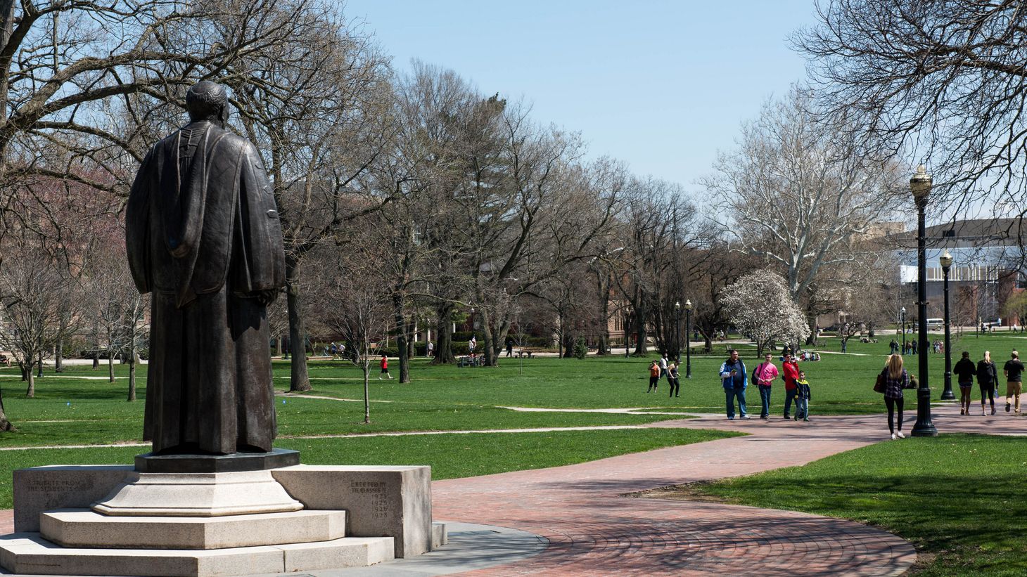 Oxley statue on the oval with students walking nearby