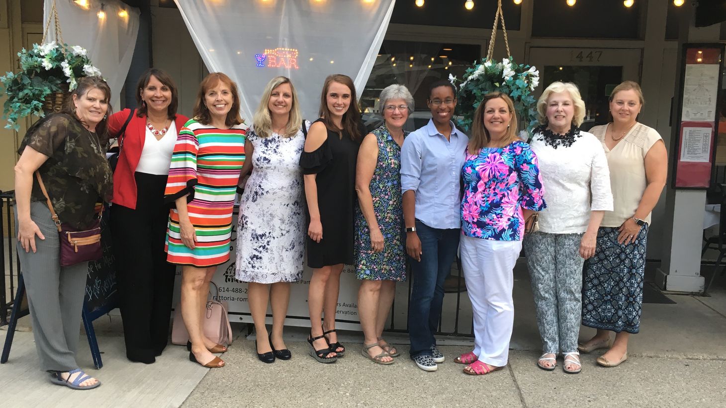 Nursing Alumni Society board members in front of a restaurant.