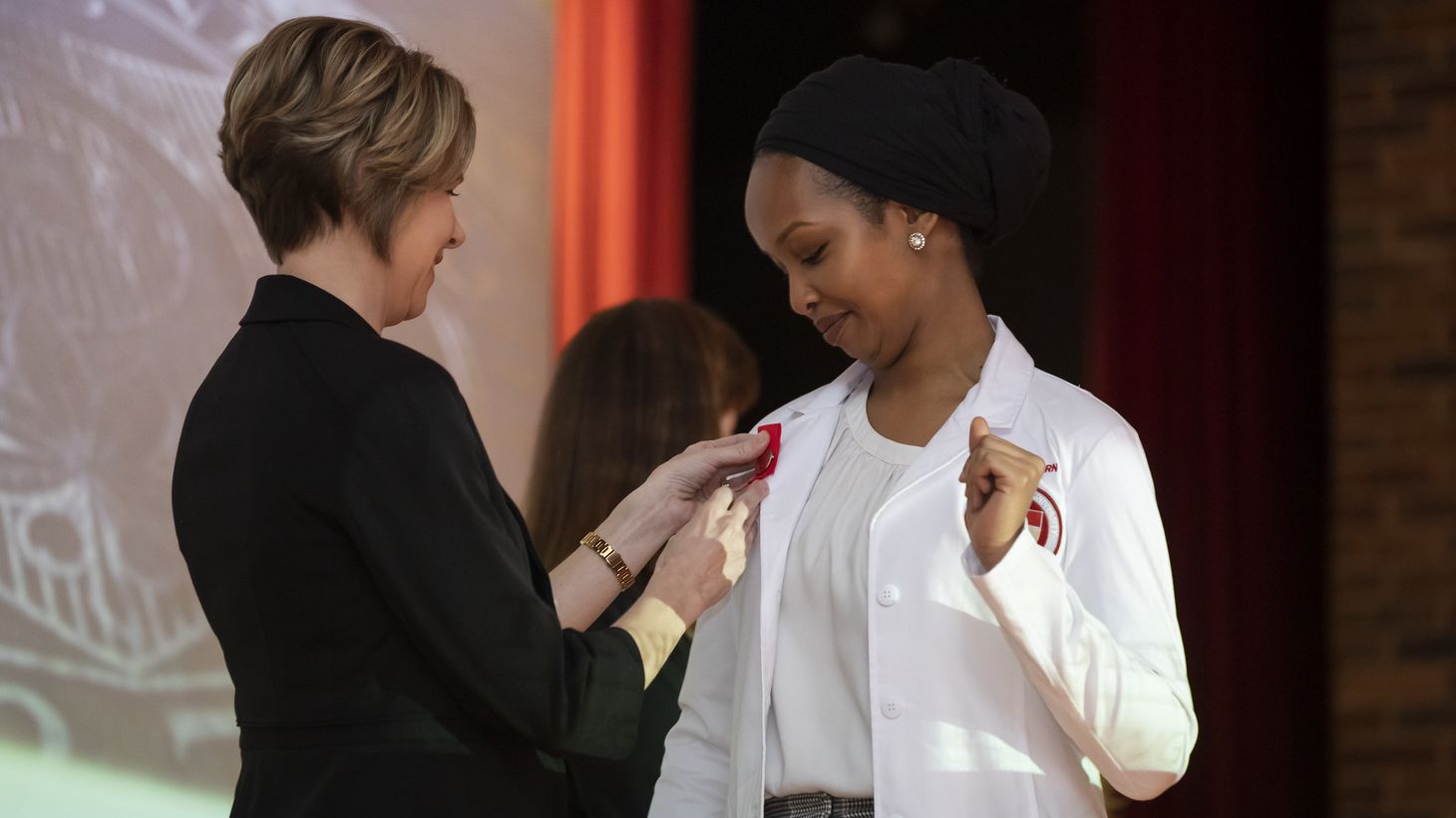 Student receiving pin at 2019 Graduate Entry Pinning and White Coat Ceremony