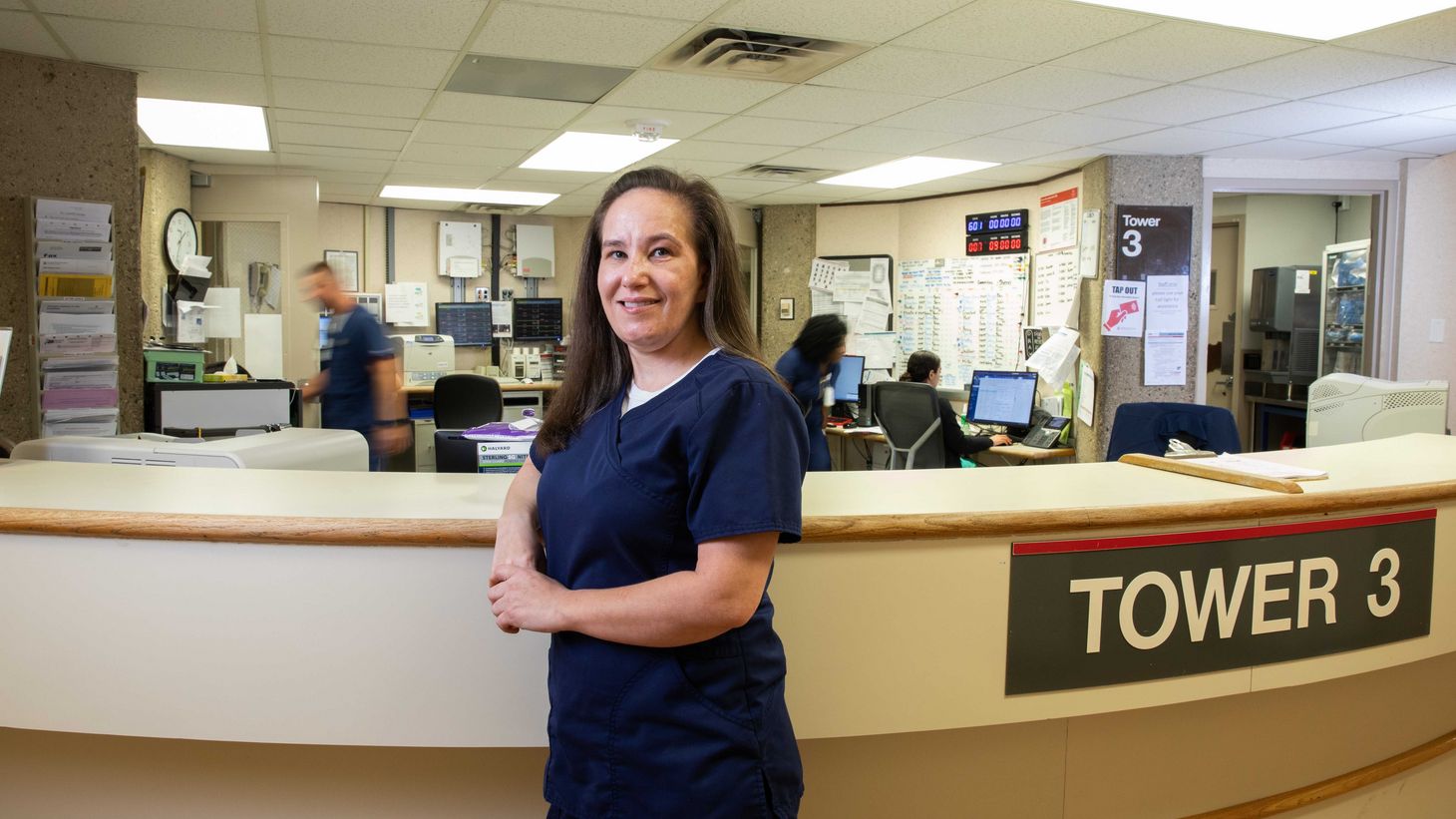 Maria Winner poses at nurses station at Ohio State East Hospital