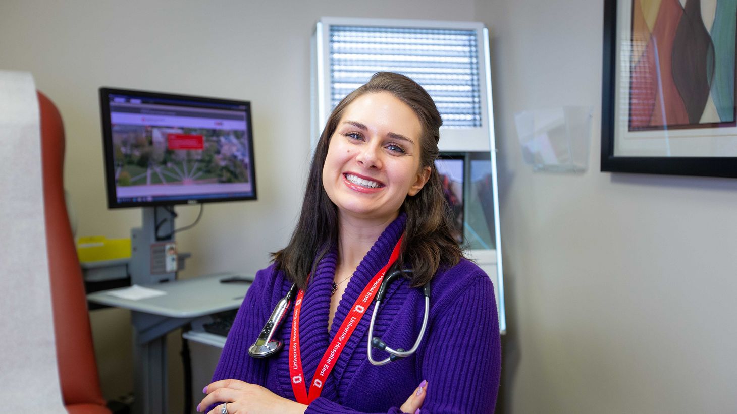 nurse practitioner in front of telehealth equipment