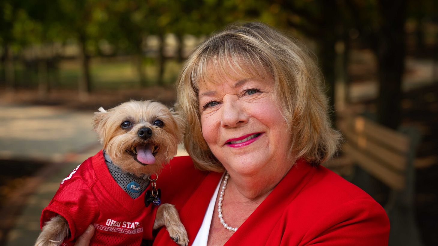 Linda Connor with her dog in an Ohio State jersey