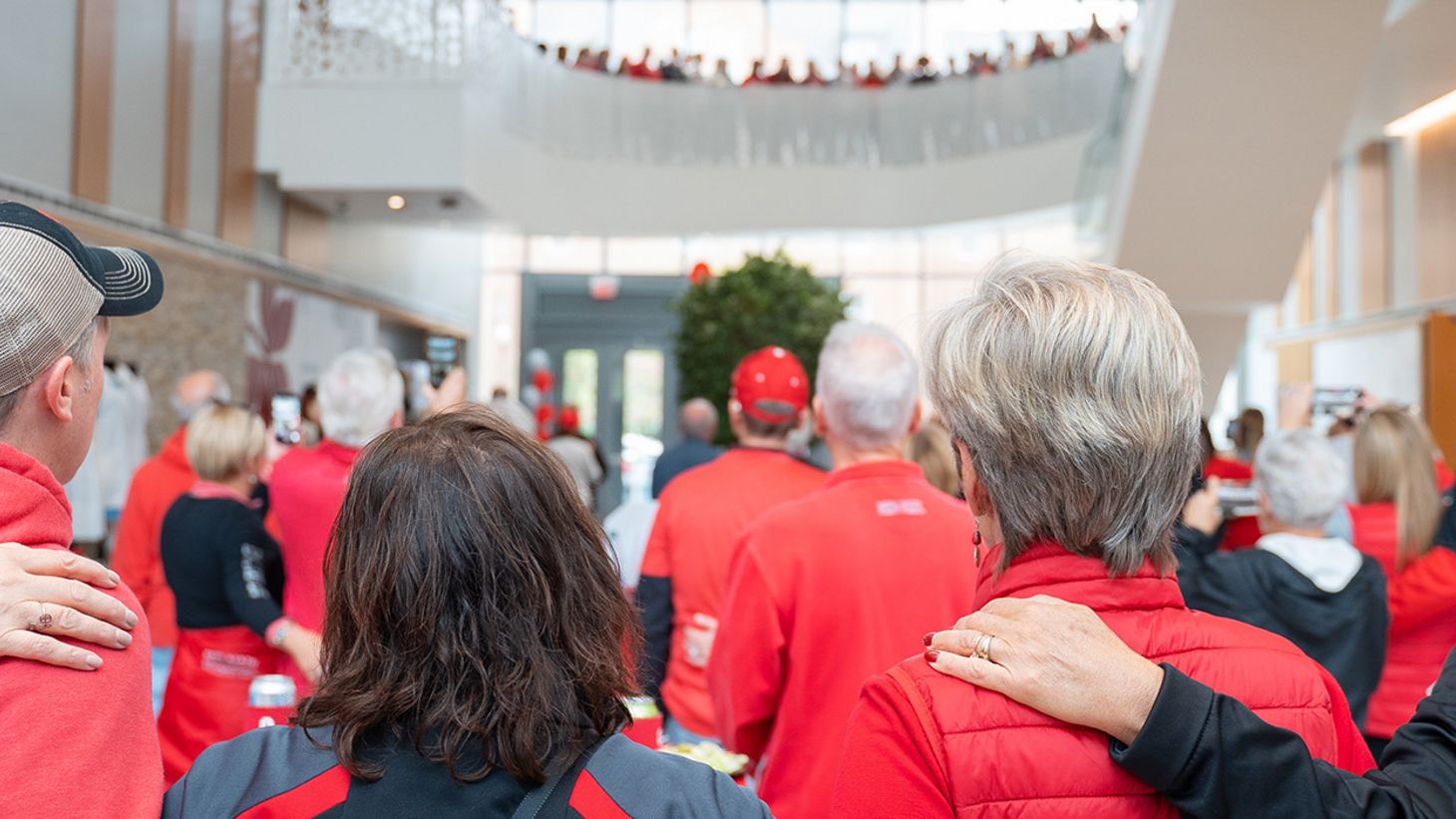 alumni and friends embrace in the atrium of Jane E. Heminger Hall at Homecoming