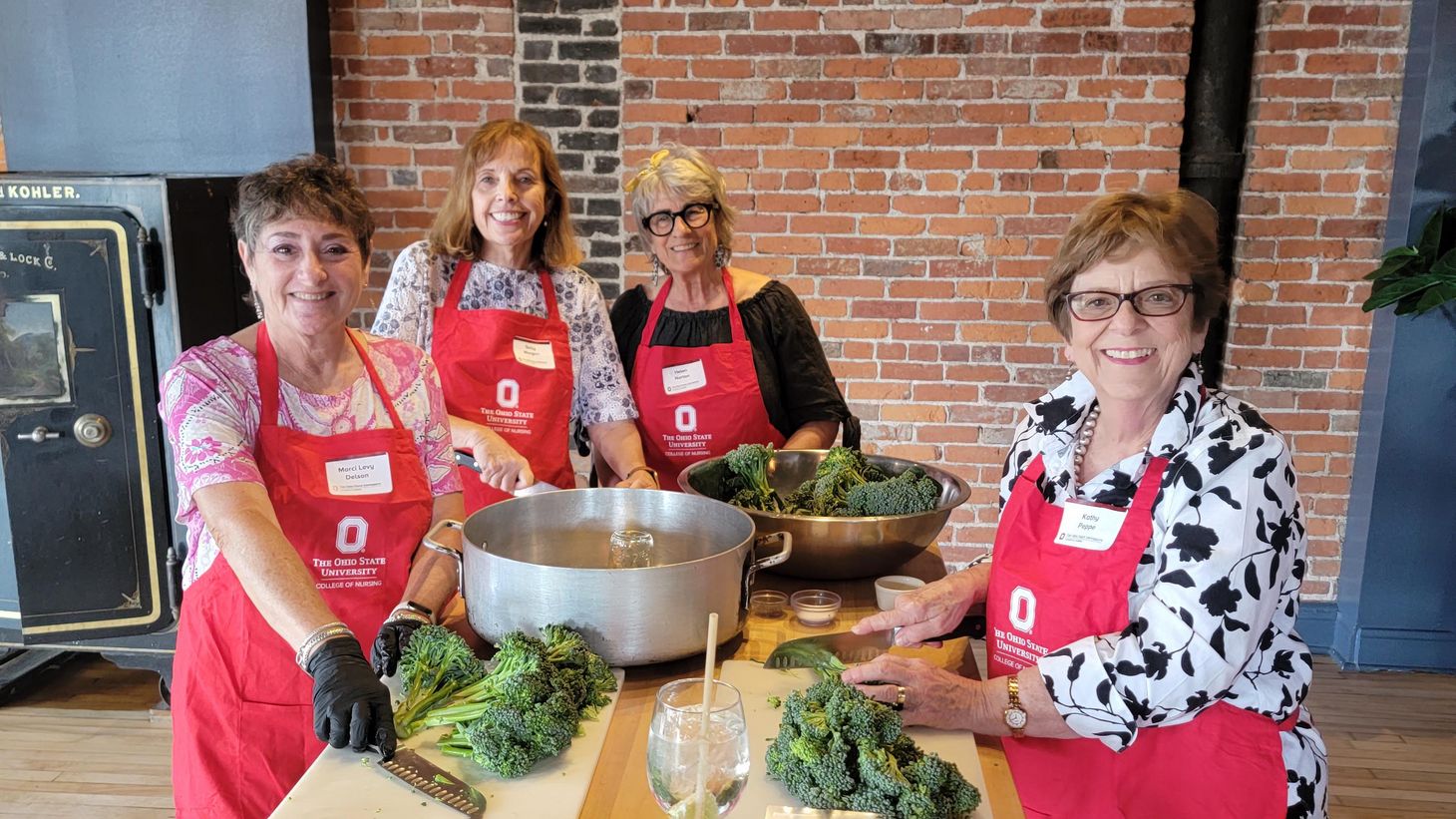 alumni society members pose during Buckeyes in the Kitchen event