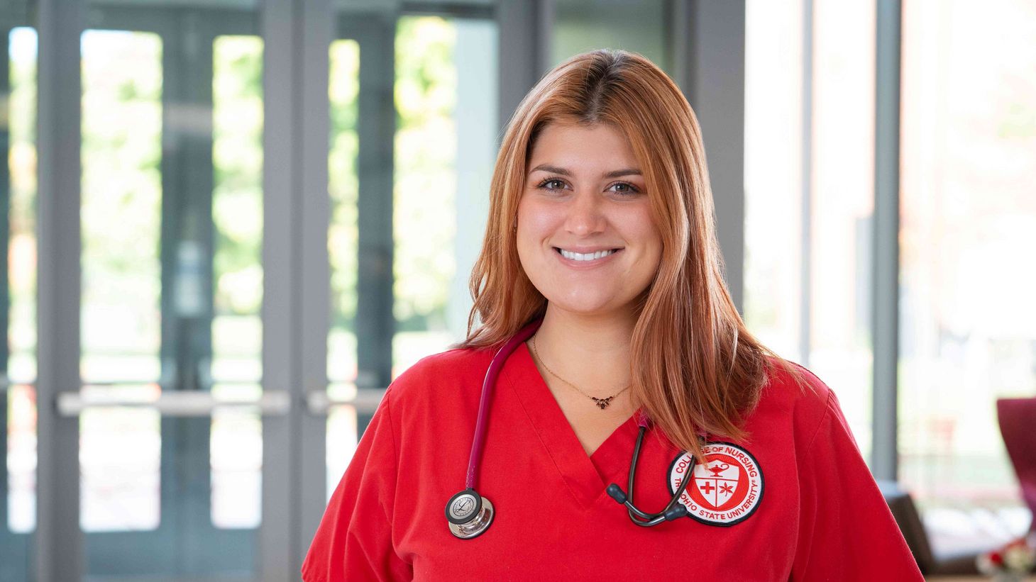 female student nurse in red scrubs