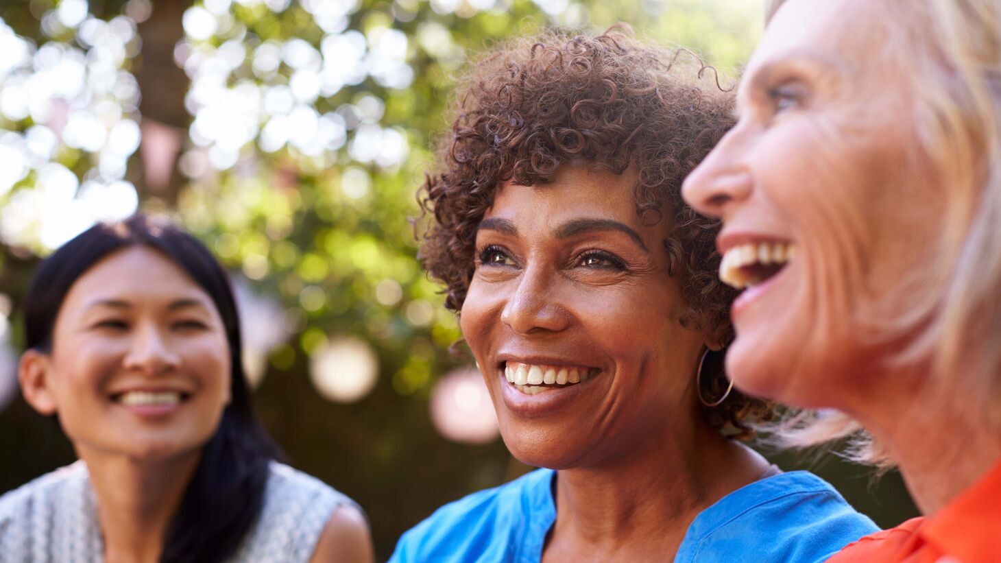 3 older women outside laughing and smiling