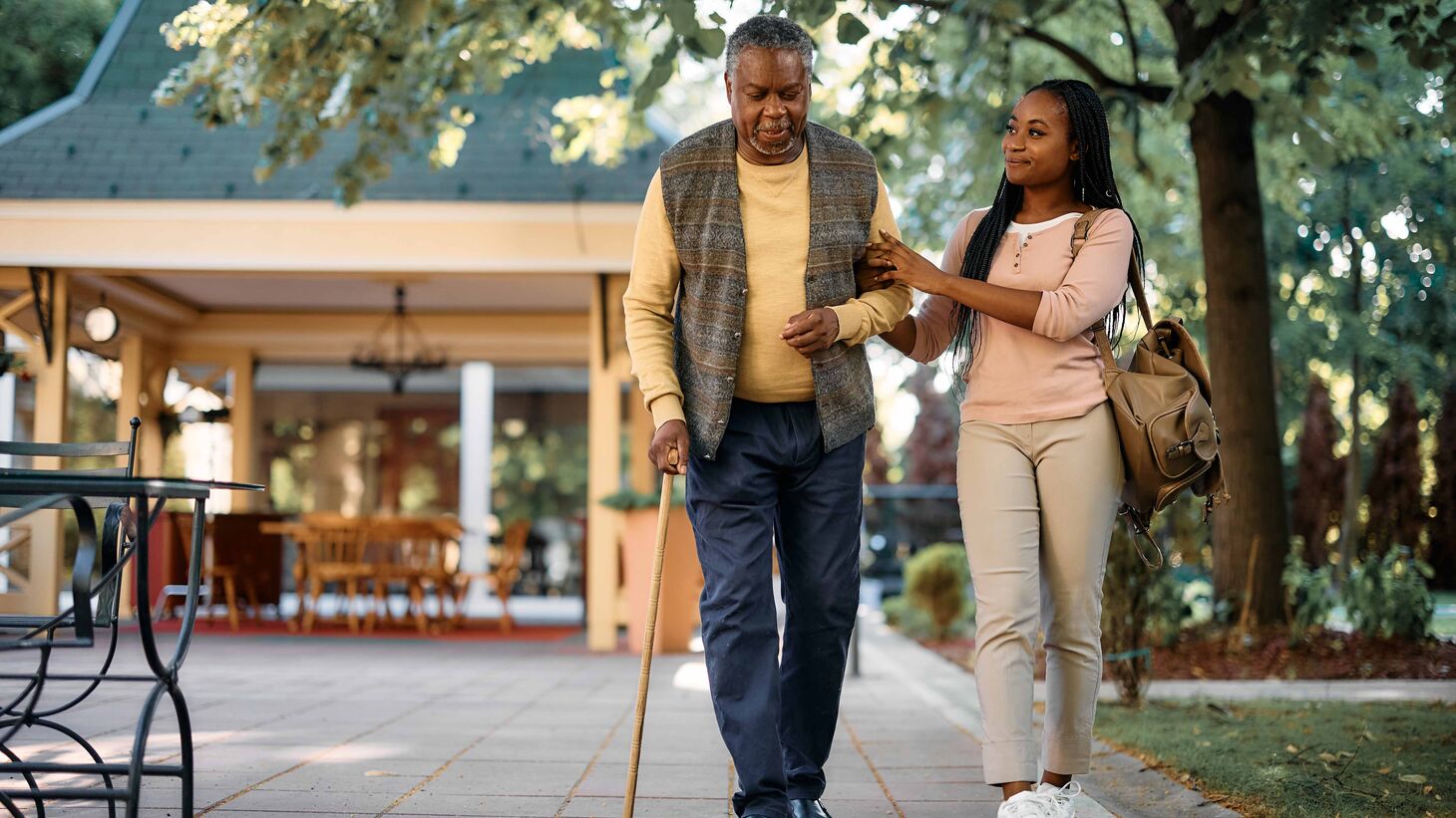 Young woman walks happily with elder man