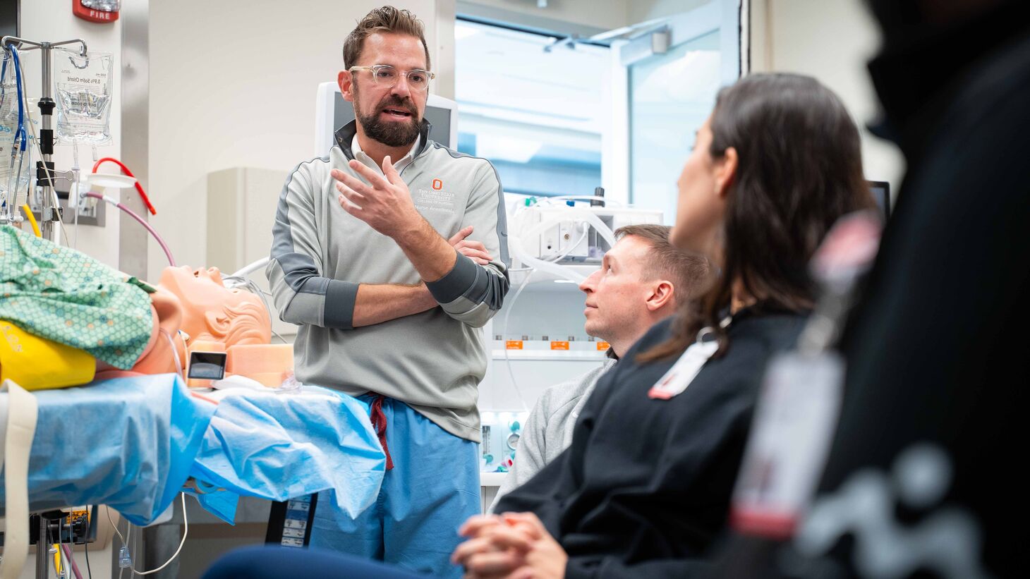 Nurse Anesthesia students learning in simulation lab from director