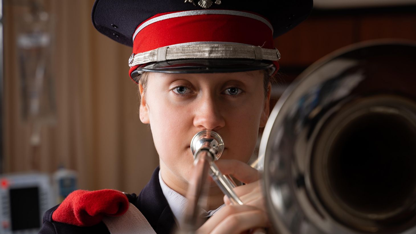 nursing student with trombone in marching band attire