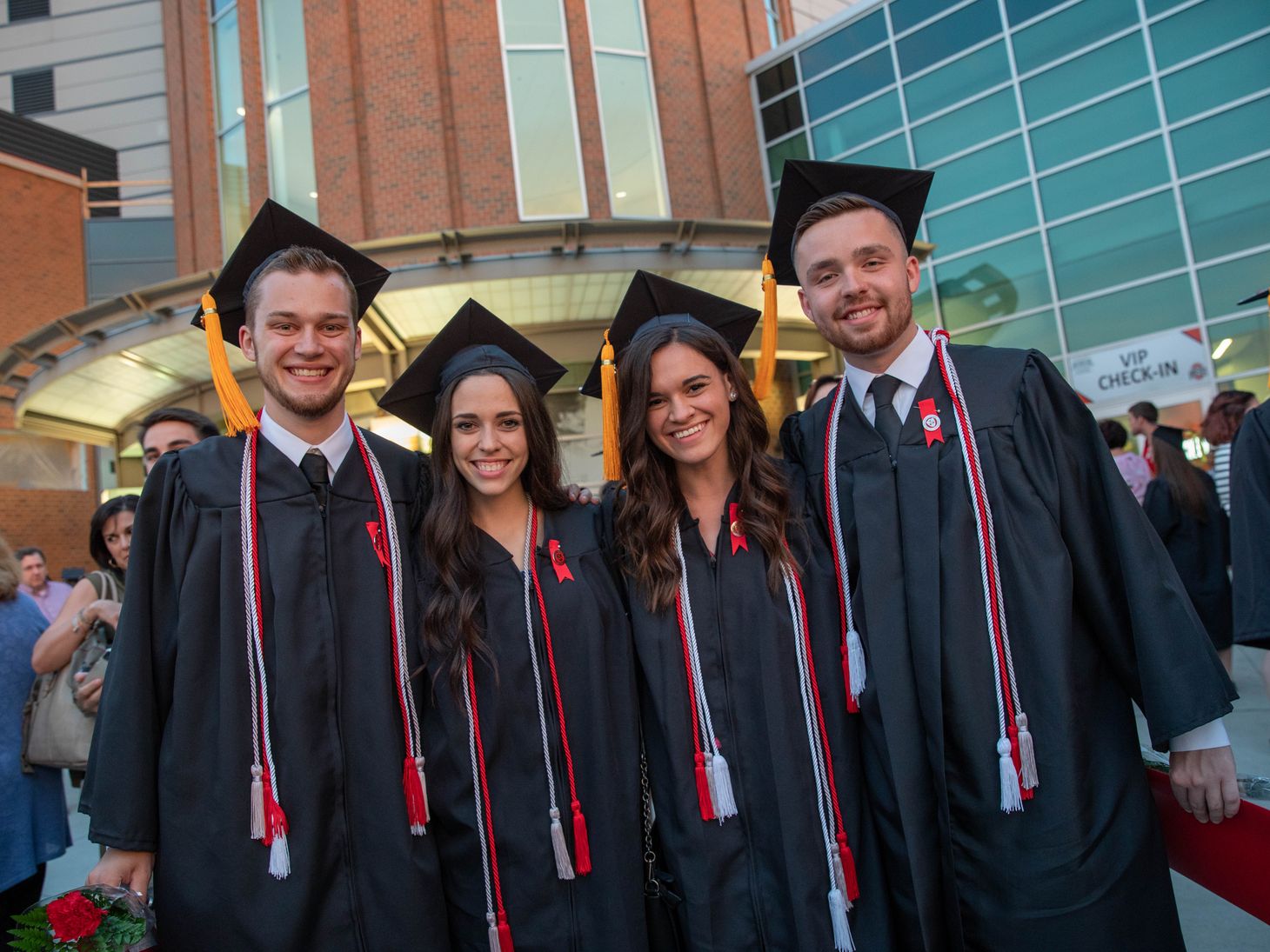 Ohio State students pose together outside of the Schottenstein Center before their Convocation ceremony