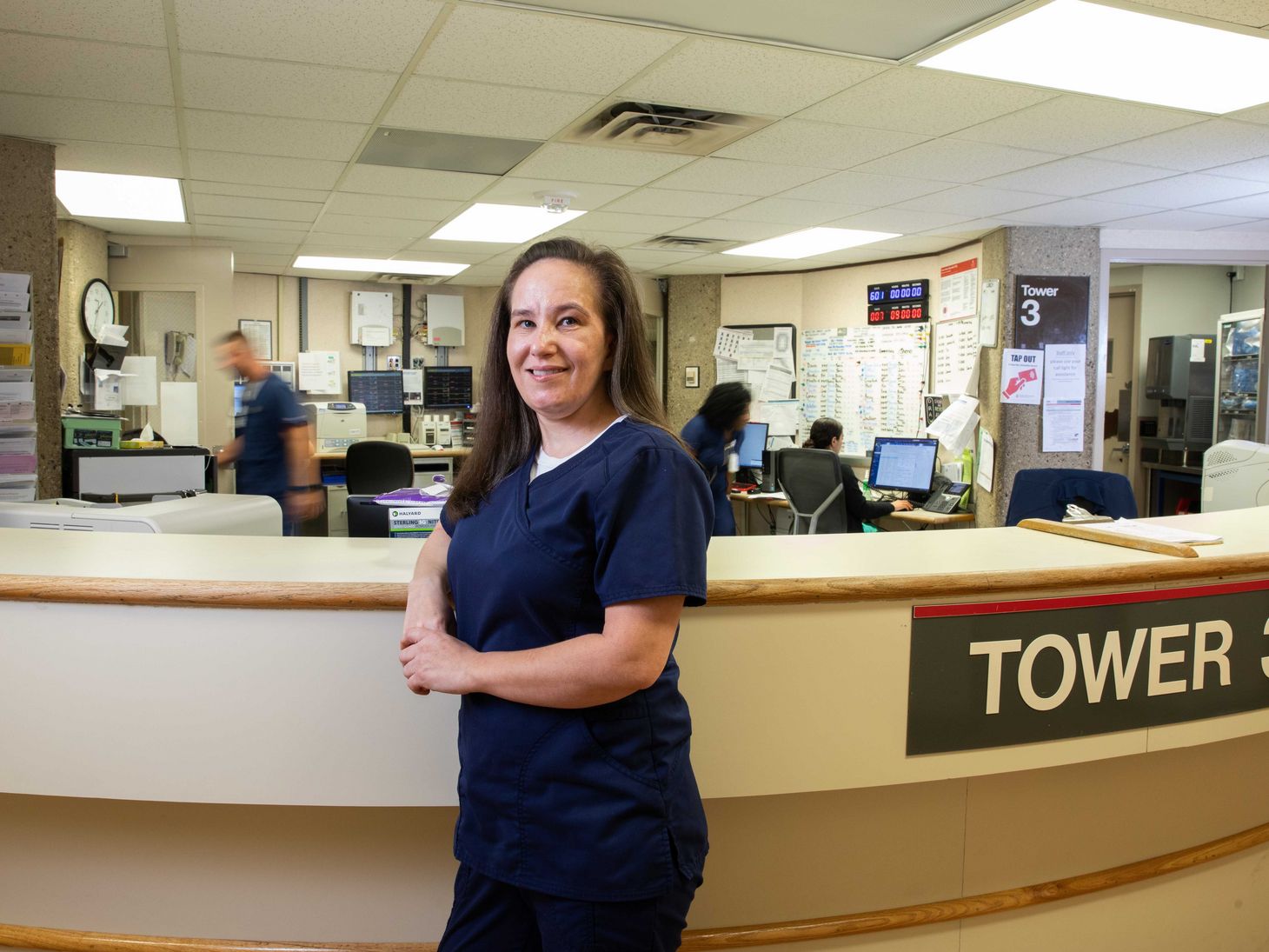 Maria Winner poses at nurses station at Ohio State East Hospital