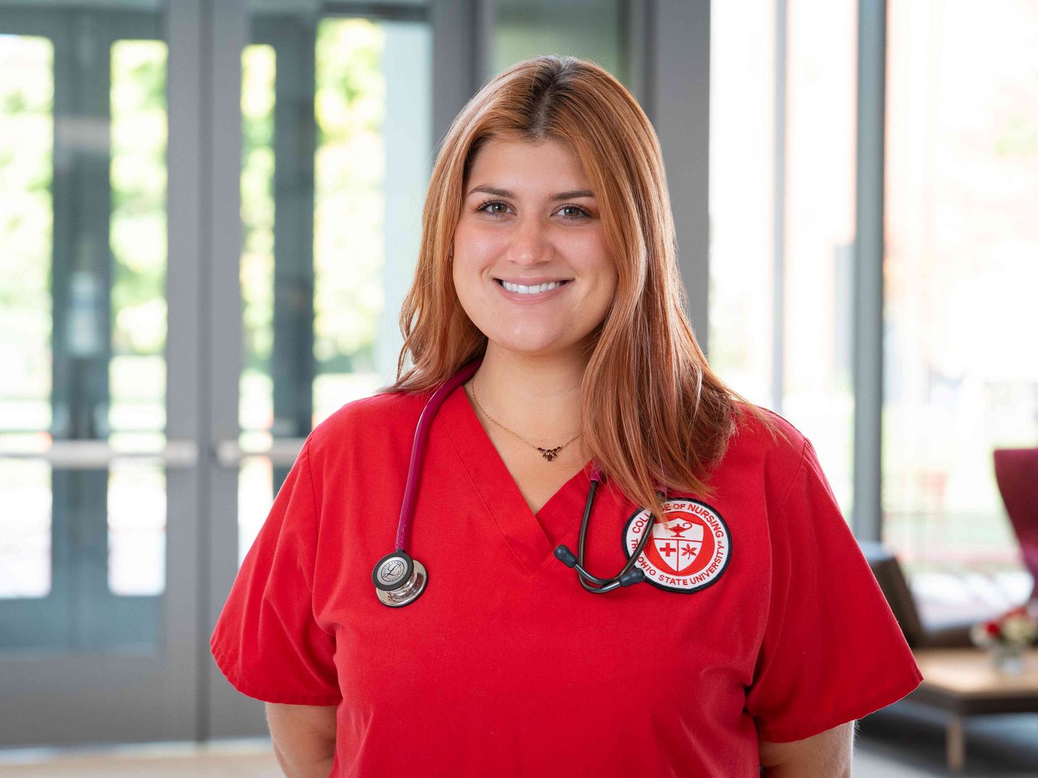 female student nurse in red scrubs