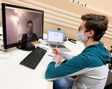 student with mask using computer