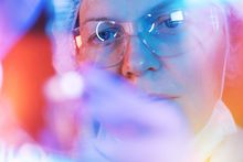 closeup of researcher looking at test tube