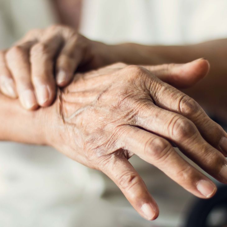 hands of an elderly person gripping wrist