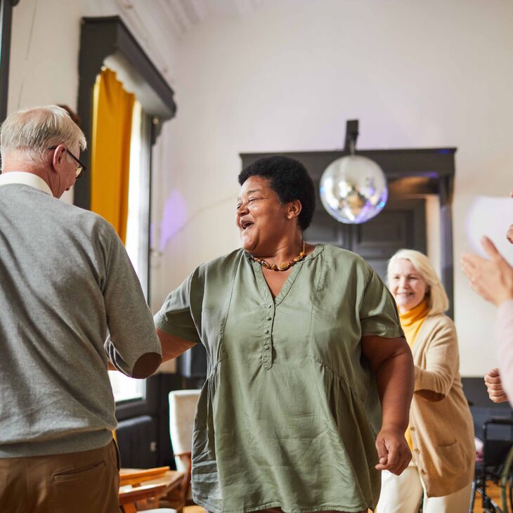 group of people clapping and smiling