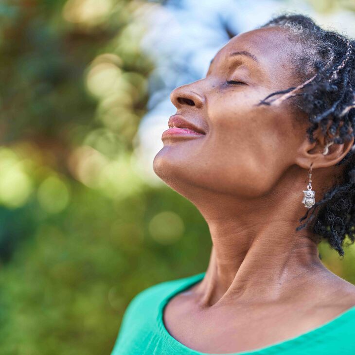 African American woman outside practicing mindfulness