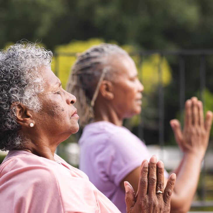 Two older African American women practicing mindfulness