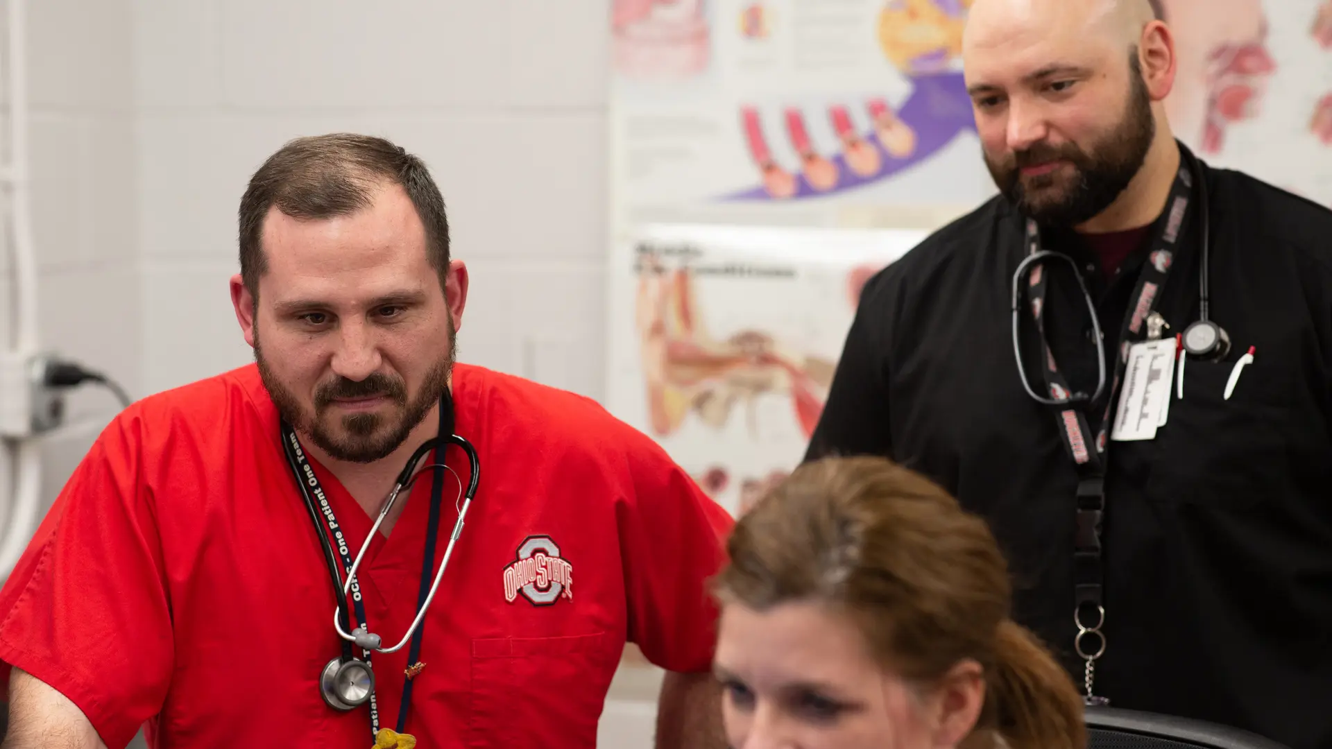 nurse in red scrub on the floor with preceptors