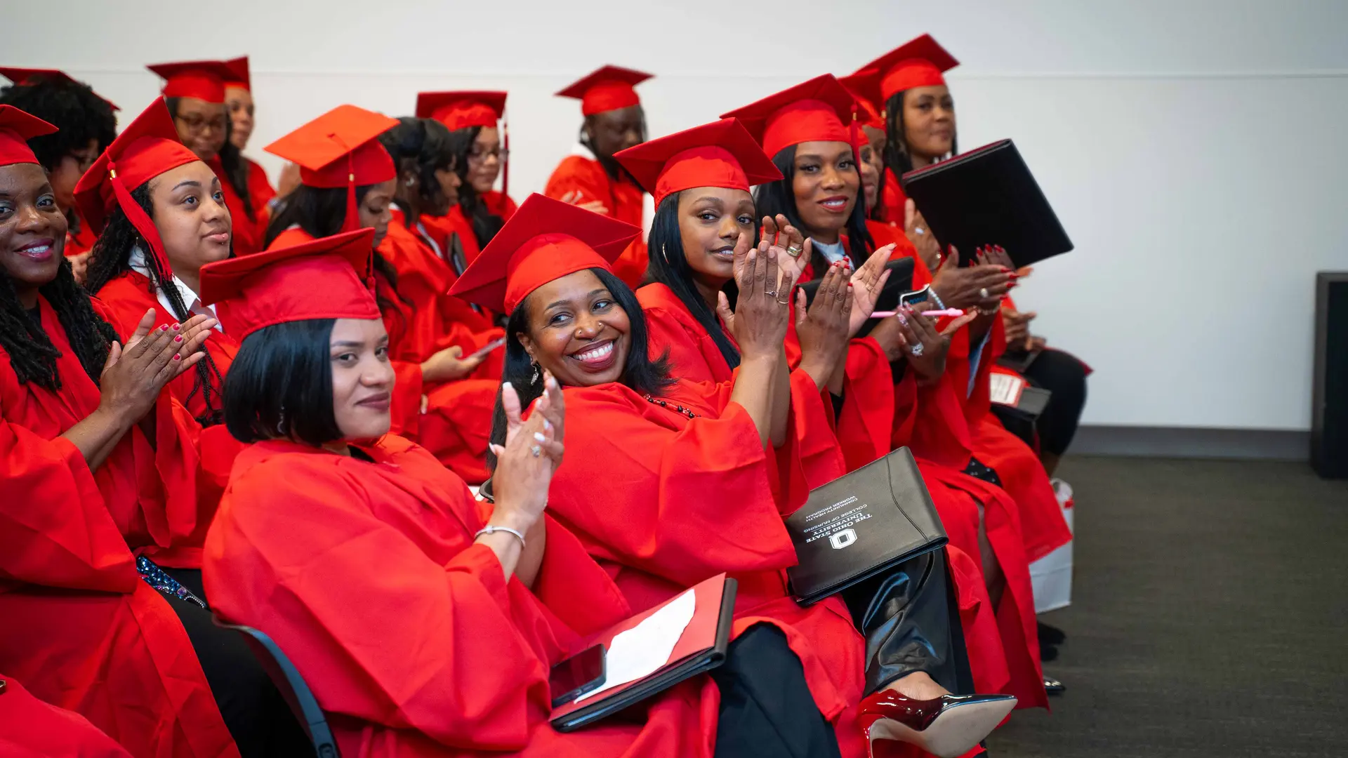 Community Health Workers in scarlet regalia at completion ceremony
