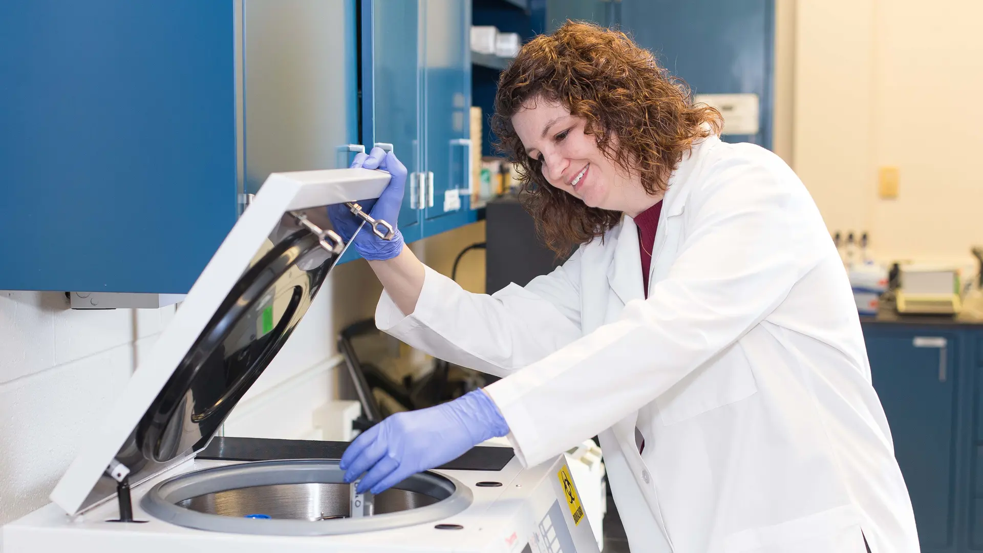 PhD candidate in the lab conducting research