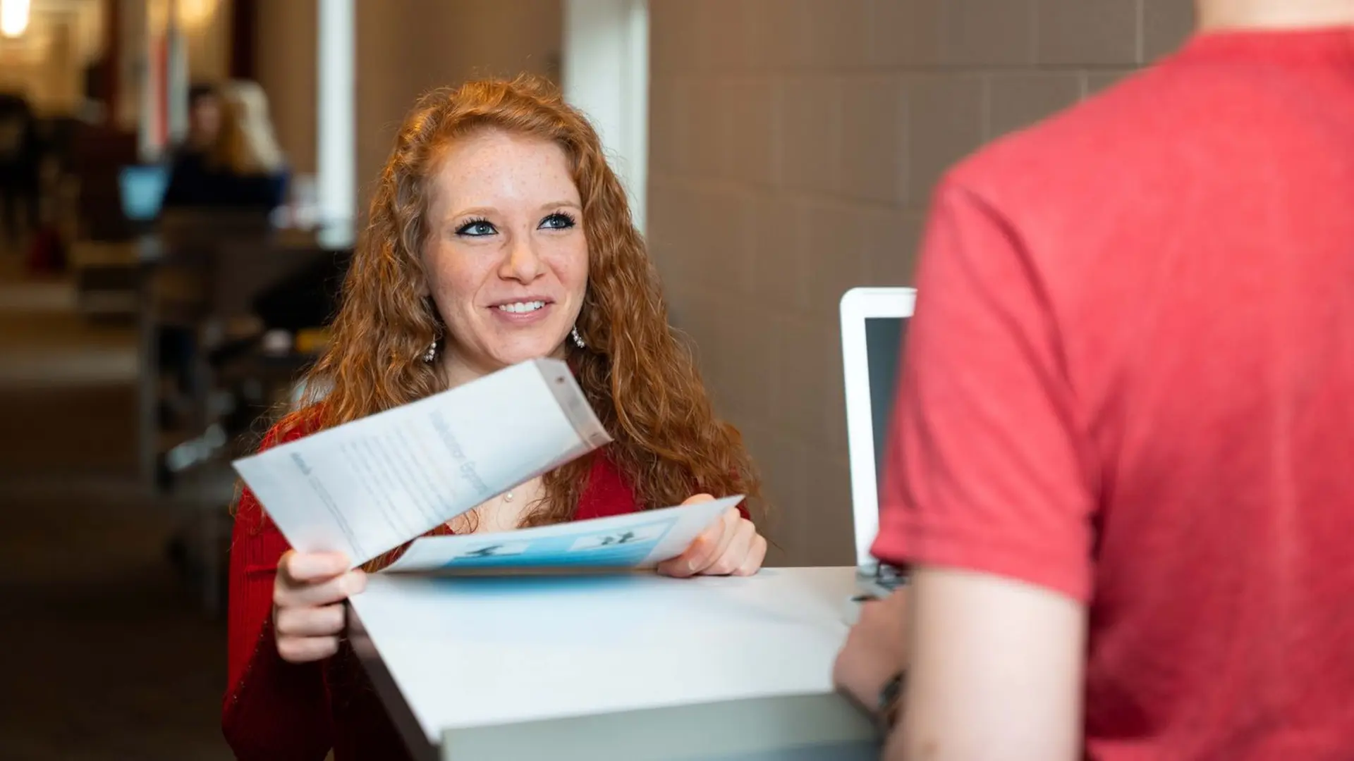 student hands in paperwork