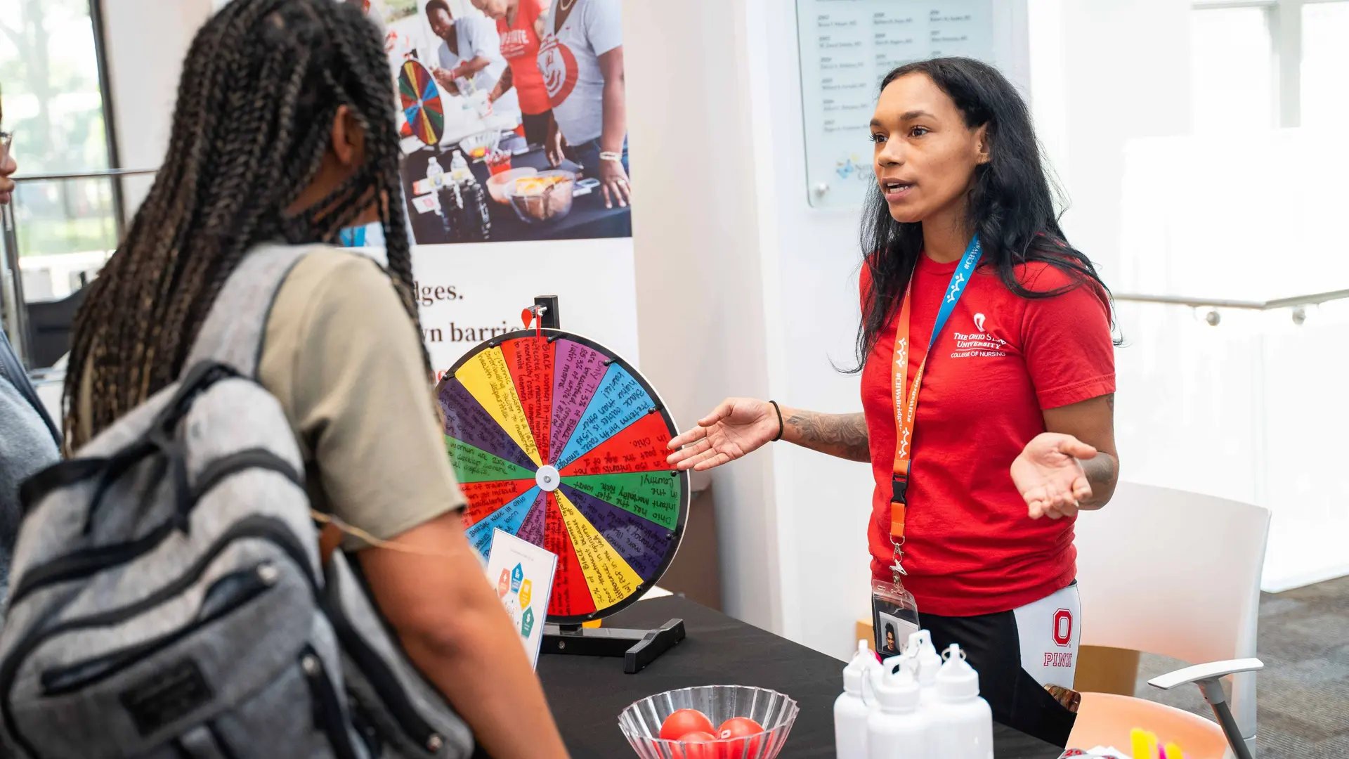 Community Health Worker talking with community members during Healthy Community Day