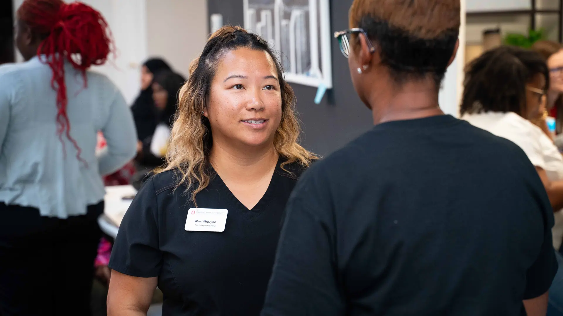 Community Health Worker talking with community members during Healthy Community Day