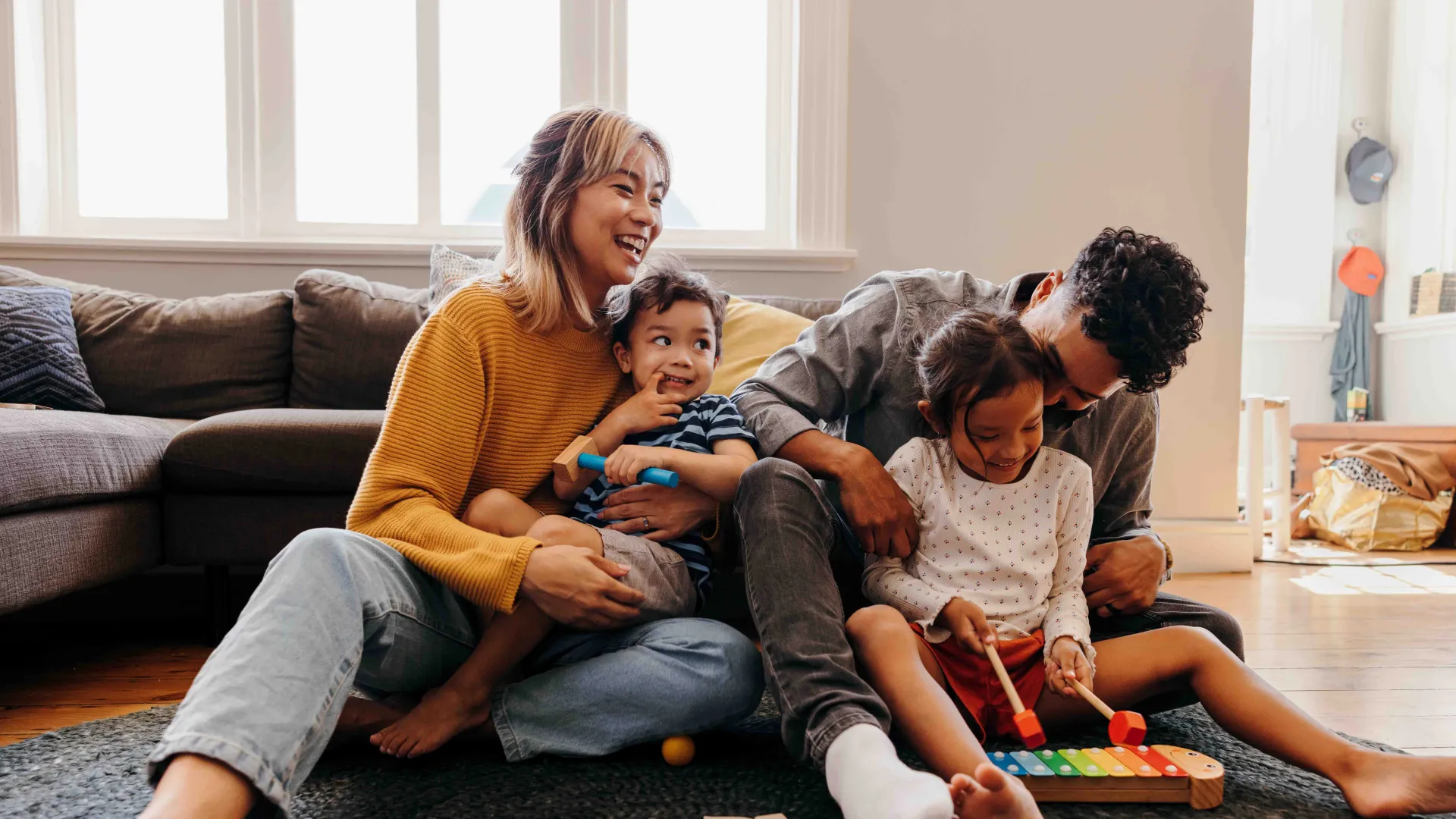Young parents having fun with their children at home
