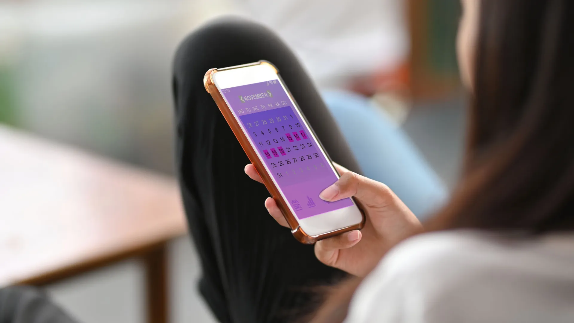 Woman using fertility tracking app on her phone