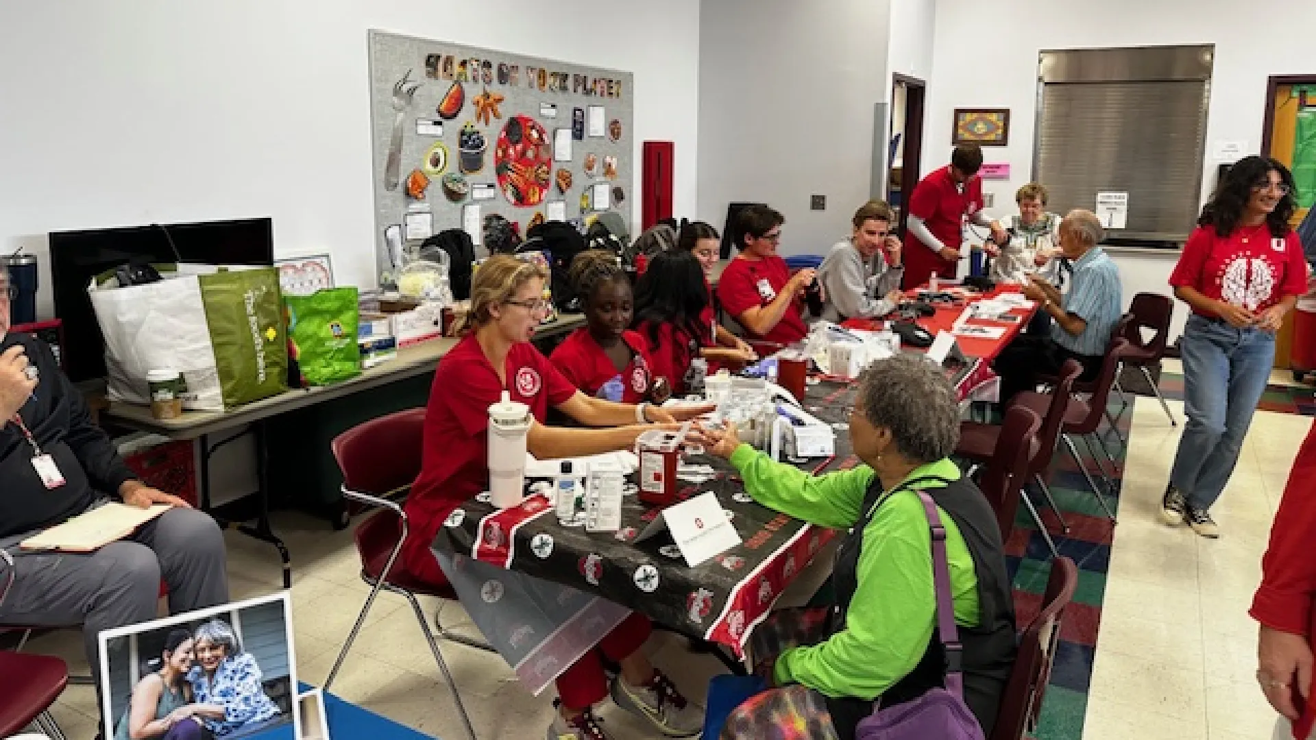 Ohio State nursing students providing health screenings including blood pressure and glucose monitoring.