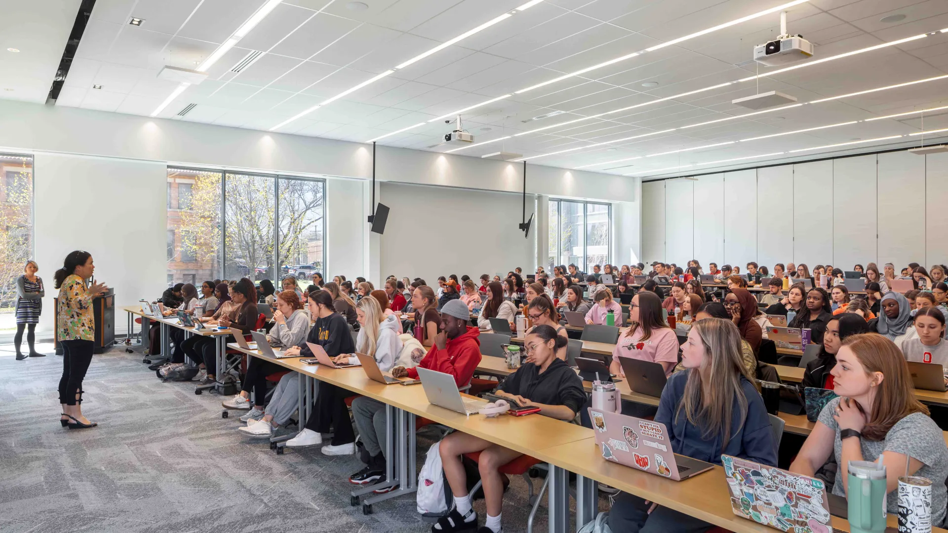 Photography ©️Brad Feinknopf professor lecturing a classroom full of students 