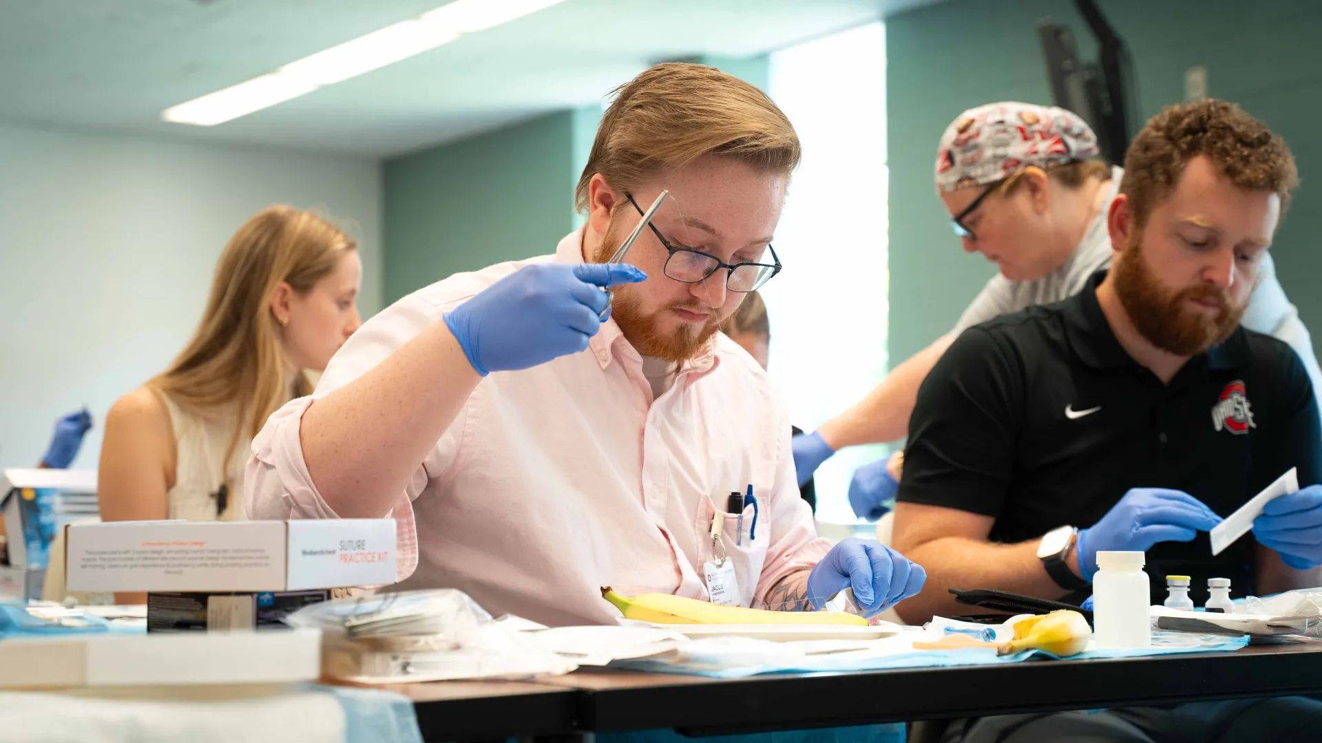 student practicing suturing during lab