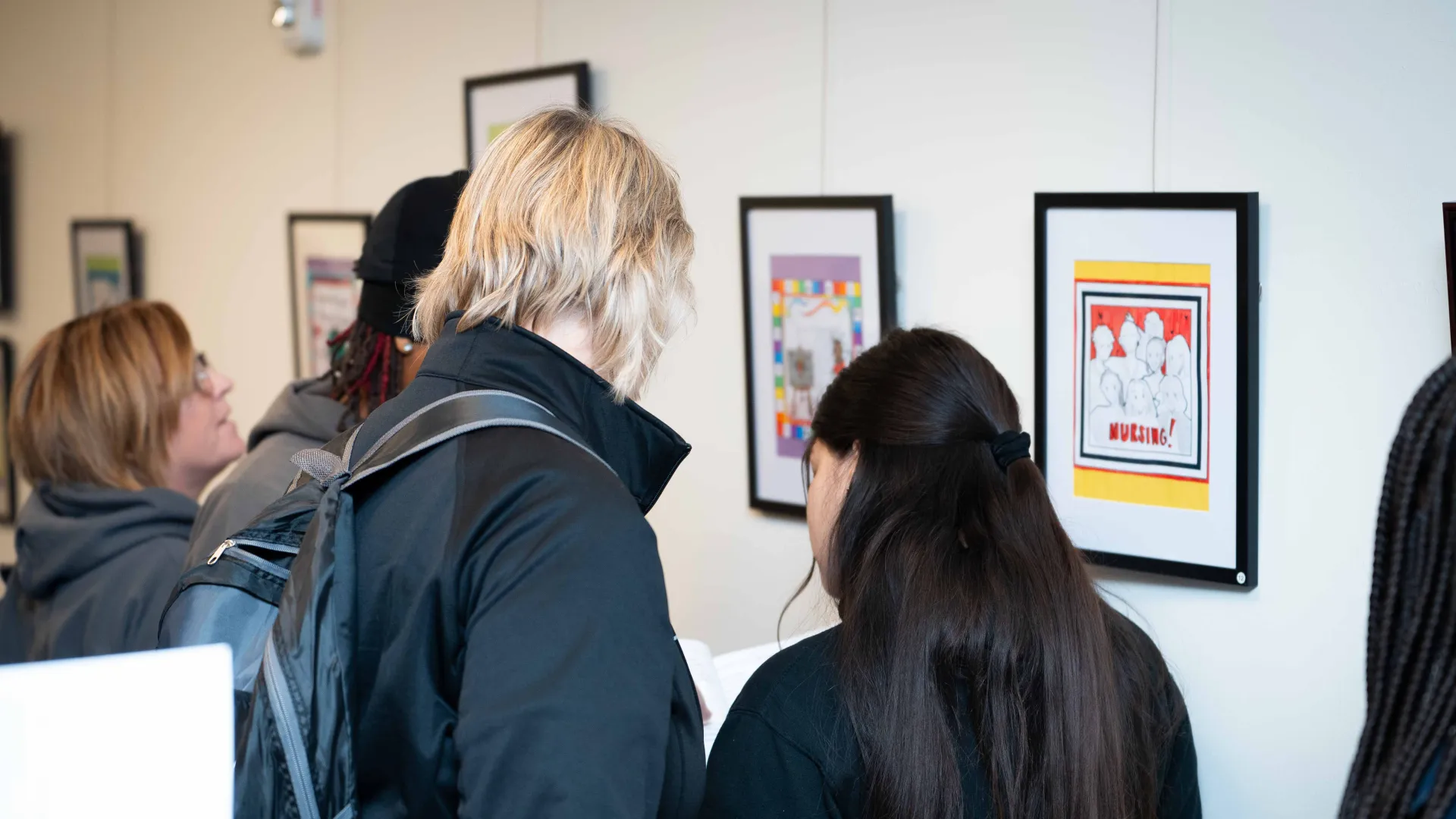 Two students standing in front of artwork