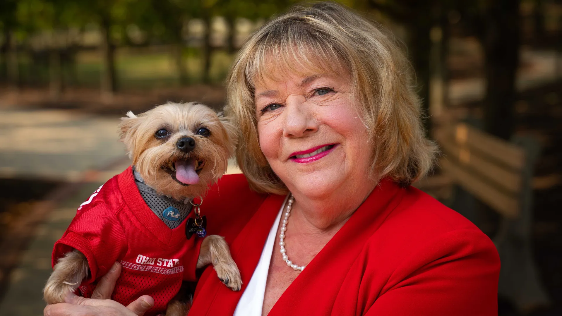 Linda Connor with her dog in an Ohio State jersey