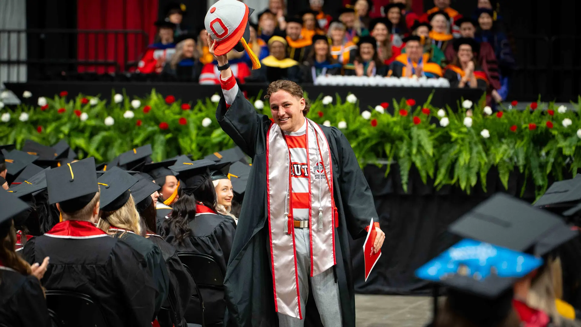 Caleb Kies reveals himself as one of the Brutus Buckeye mascots at Convocation