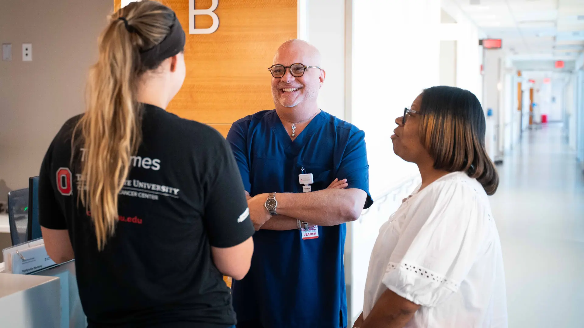 hospital staff, nurse leader and nurse talking in hallway